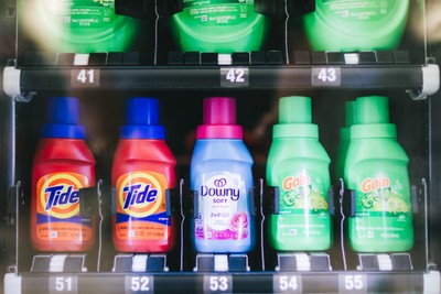 Vending machine stocked with Tide, Downy, and Gain detergent at Fresh Fold