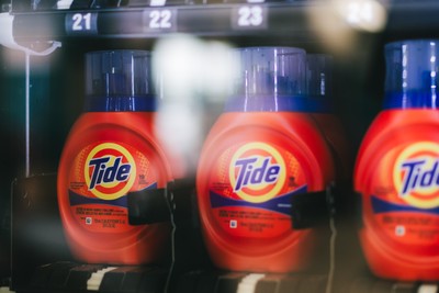 Tide detergent bottles lined up in the vending machine at Fresh Fold